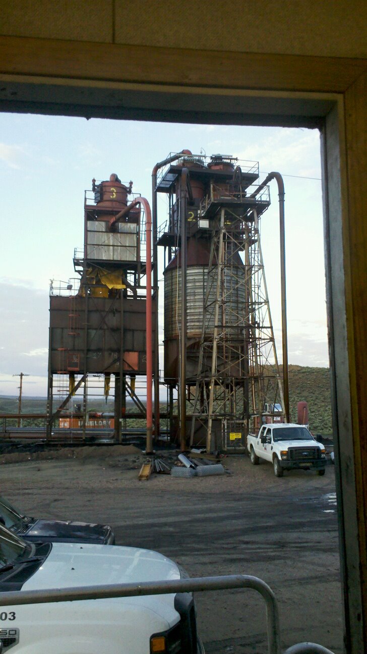 Gilsonite surface plant and ore silos at dusk, seen from the shop door