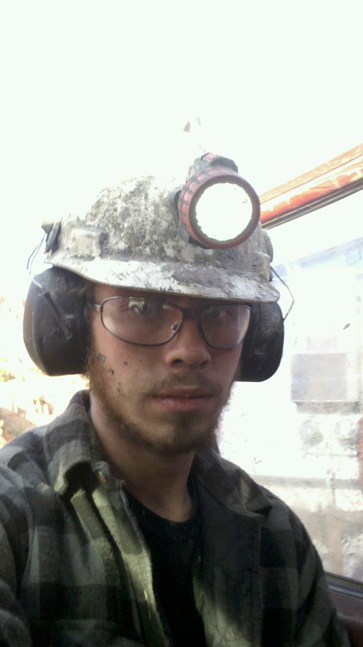Rocky in a hardhat and lamp during his first week uranium mining